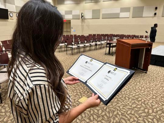 Melanie Cedeño-Lopéz, MFA Features Film Production major, looks at her certificate after winning first place on the Master's Category at UCF's three minute thesis event on Nov. 15 in the Morgridge International Reading Center.
Ruby Marisol Merced