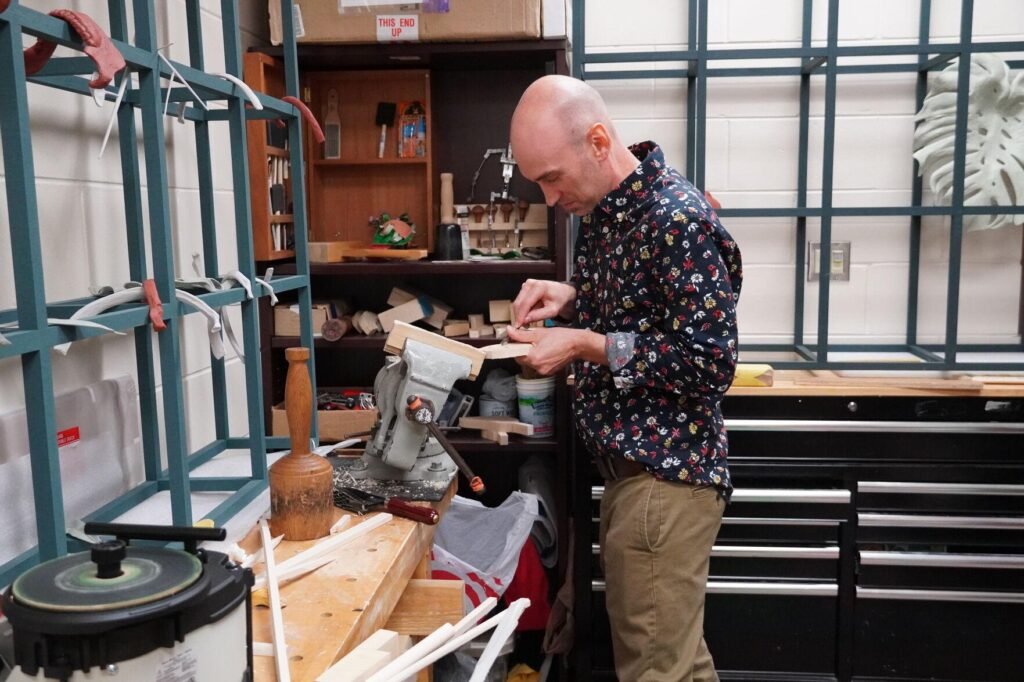 Robert Aiosa demonstrates how to carve wood sculptures in his office on Friday. Aiosa is currently teaching a foundation 3D design course, but he specializes in woodworking.
Marisol Merced